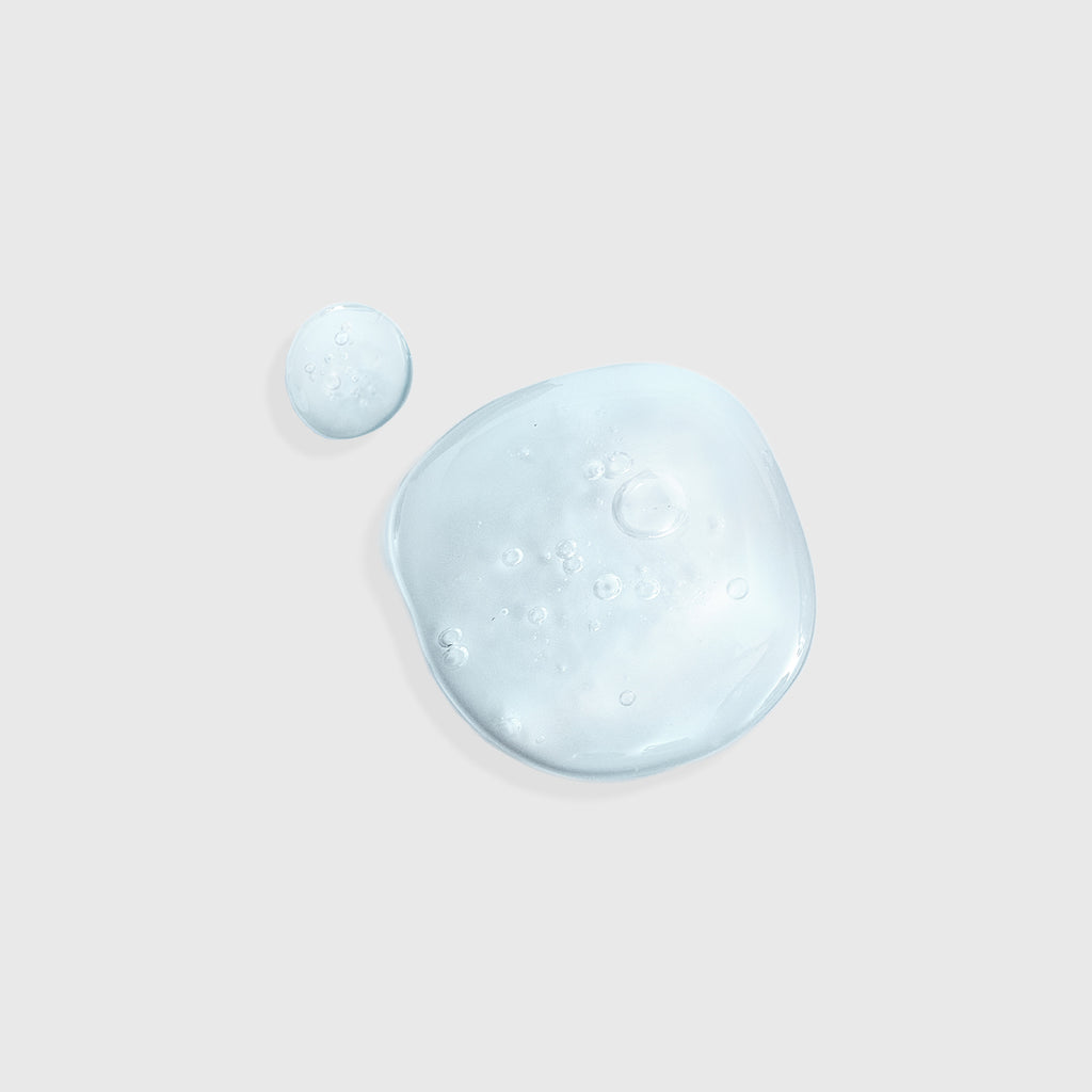 Two droplets of hyaluronic acid serum on a gray background, 
best hyaluronic acid serum, Timexpert Hydraluronic 3d force serum gel texture, product gel texture