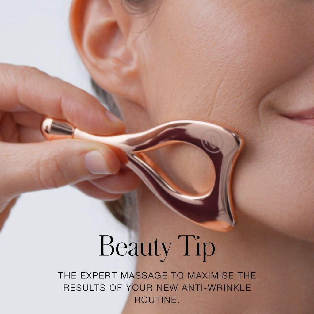 Person using a beauty tool on their face with text about anti-wrinkle routines.