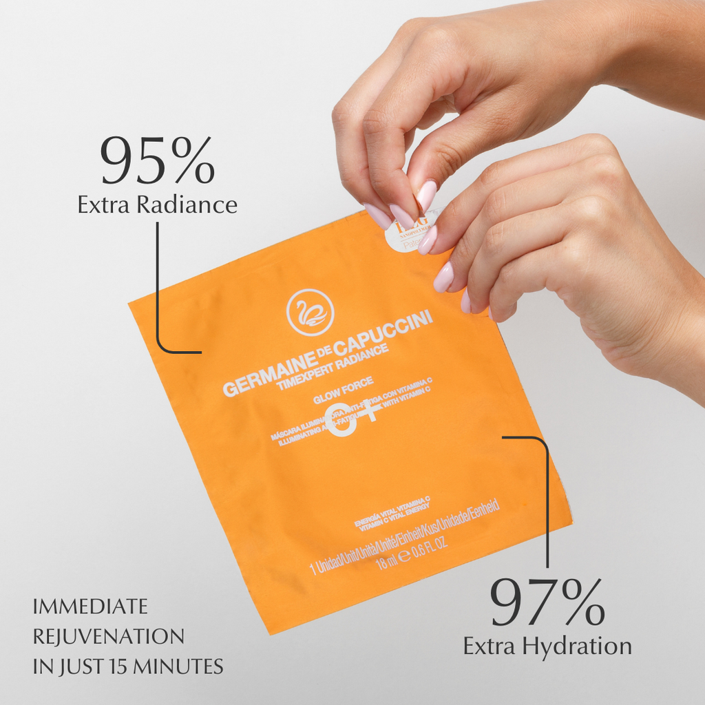 vitamin c facial mask packet with text highlighting radiance and hydration benefits, held by a hand against a light gray background.