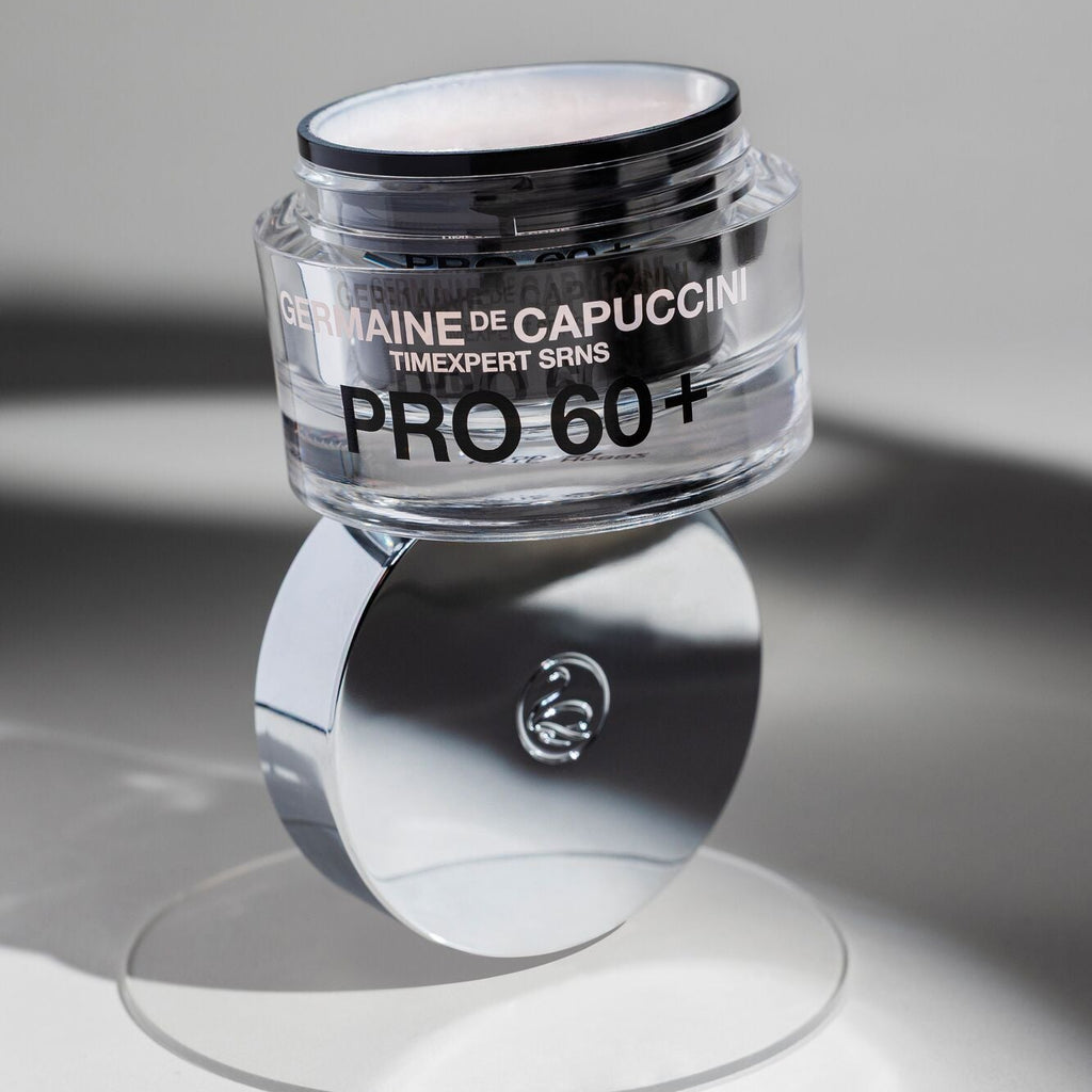 Skincare jar labeled 'Timexpert SRNS Pro 60+' for anti-ageing on a reflective surface with a neutral background