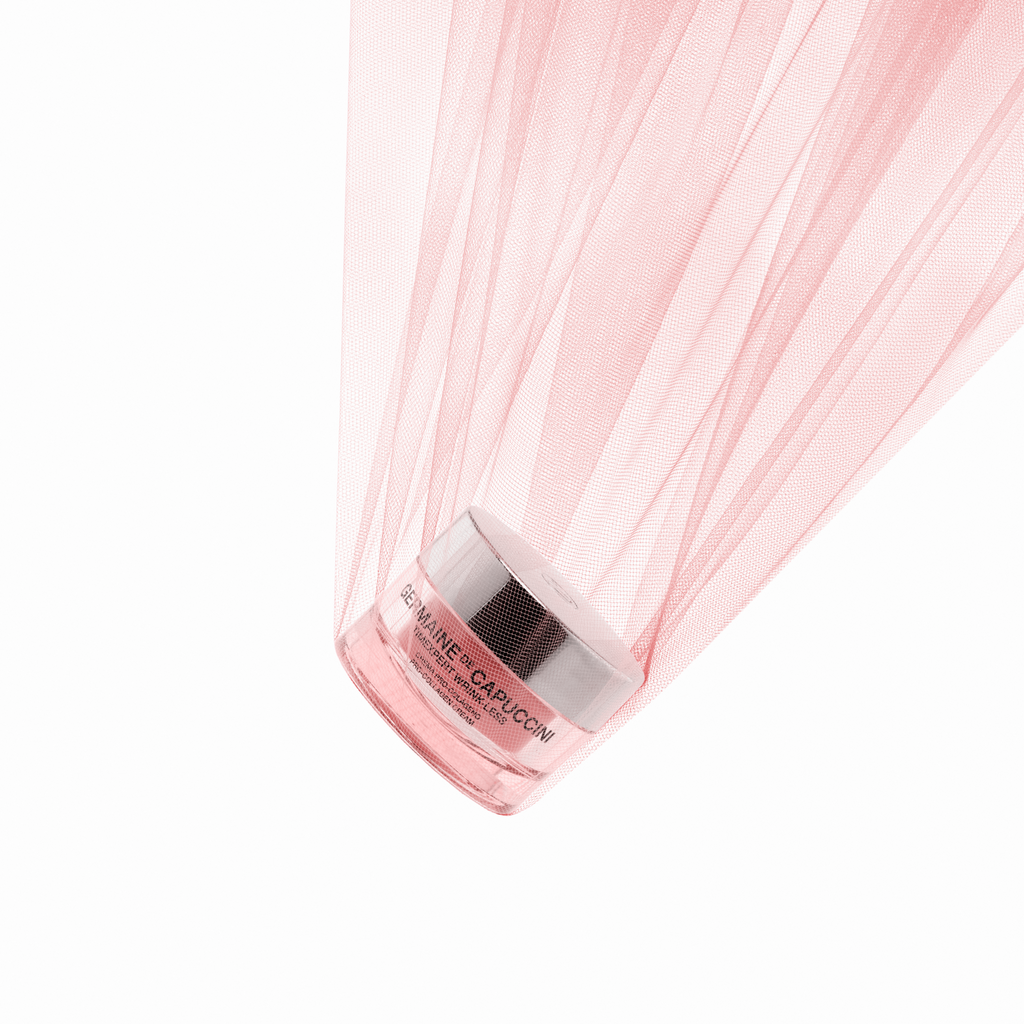 Pink sheer fabric with a anti-wrinkle skincare Jar emitting pink light on a white background